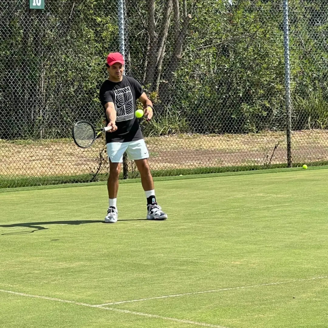 A man holding a tennis racket on the court